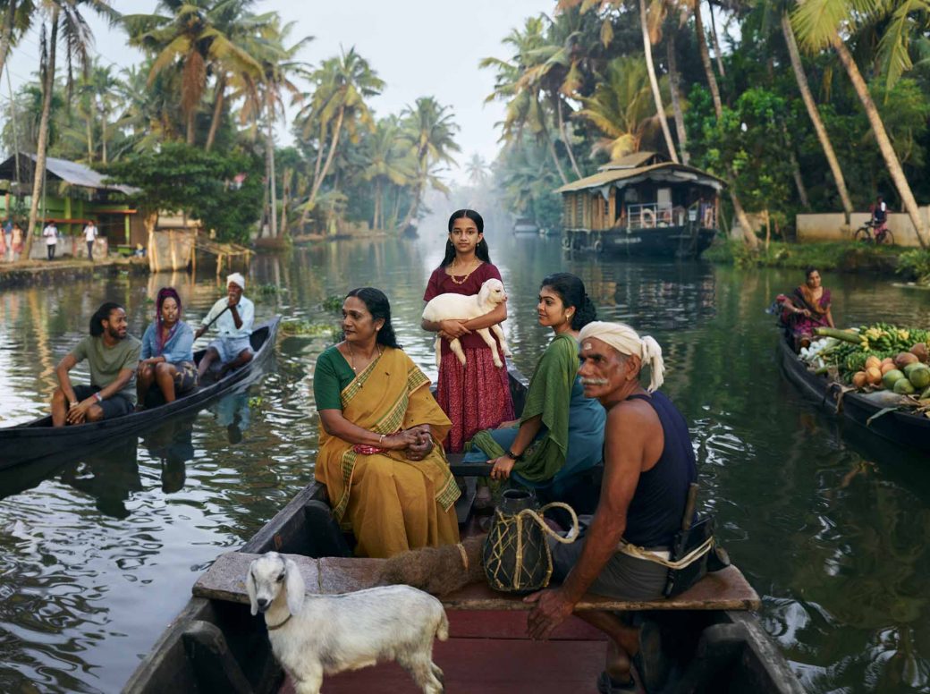 people on a boat on a river and a girl standing and holding a 