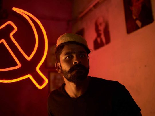 man with hat and hammer and sickle on the background