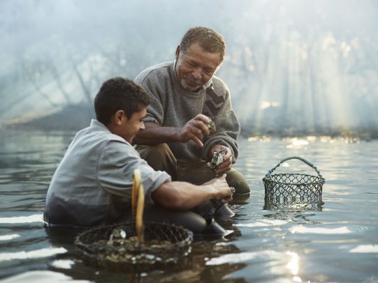 father and son working in a river for Lavazza Calendar 2016 by Joey L