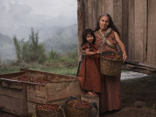 grandmother holding a basket of coffee beans and hugging her granddaughter for Lavazza Calendar 2016 by Joey L