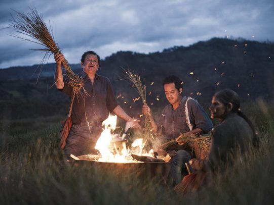Men around fire and holding long blades of grass for Lavazza Calendar 2016 by Joey L