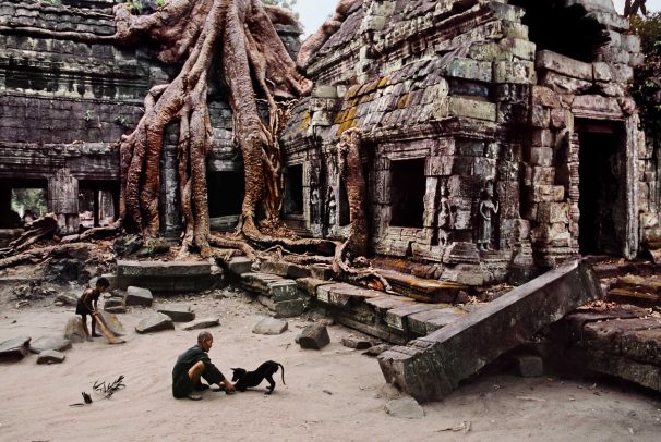 Man with dog at Ta Prohm Temple