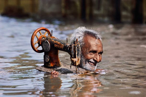 Man with sewing machine under water
