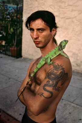 man with an iguana on his shoulder