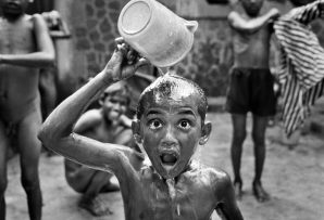 boy pouring some water on his head