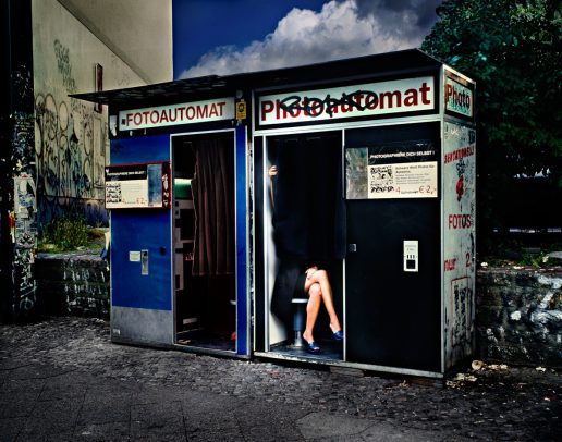 Legs of a woman under the curtain of a Fotoautomat