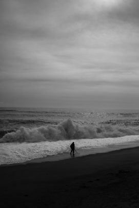 man on the beach with big waves