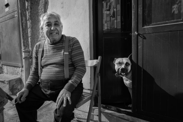 old man smiling with his dog