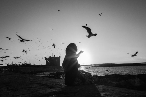 girl on the beach with seagulls