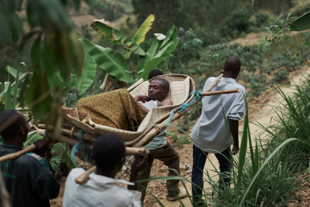 a patient being trasported by four men in the forest during Novartis annual report by Joey L.