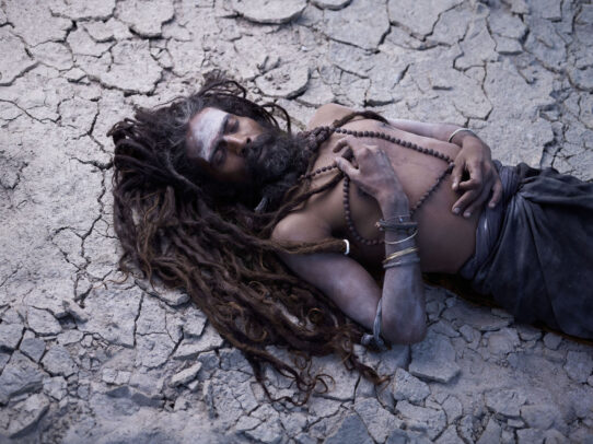 man with long dreadlock lying on the ground