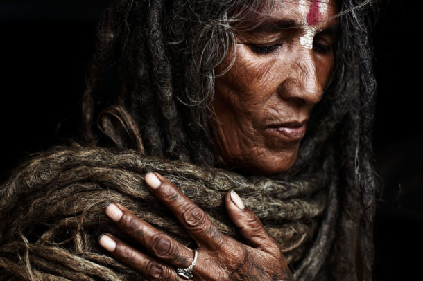 woman with closed eyes, bindi on her forehead and long dreadlocks