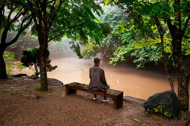 Buddhist monk sitting on a bench in Songnisan National Park