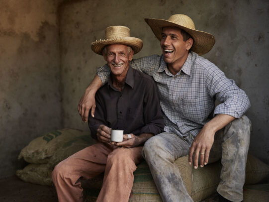 man hugging his old father who holds a cup of coffee for Lavazza Calendar 2016 by Joey L