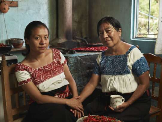mother and daughter in traditional dresses holding hands and a cup of coffee