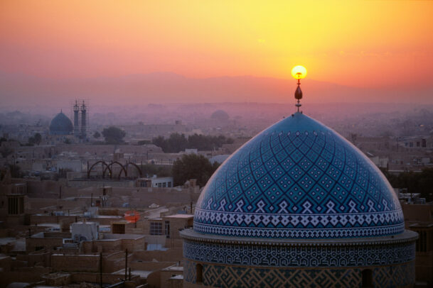 Sunset illuminates the 12th century Jame (Friday) Mosque, known for its striking blue Persian tile work. Yzad, Iran